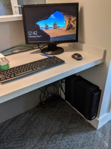 A close up of a desk with windows showing on the monitor