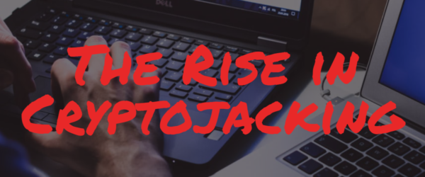 BSN-Blog-12.19.19 The Rise in Cryptojacking Banner - Featuring two laptops, with a hand typing on one