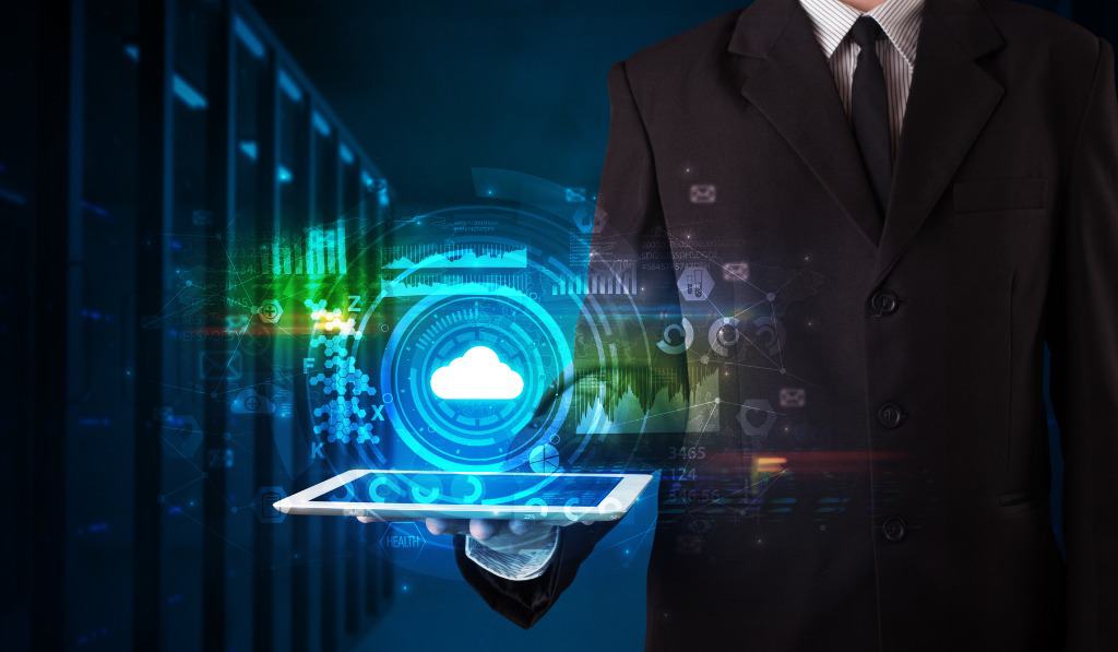 A man in a suit representing Myrtle Beach managed services with a tablet showing IT icons.