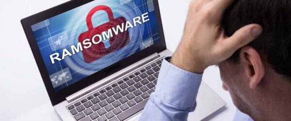 A worried man with a computer infected with ransomware in Kure Beach.