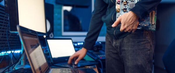 Tips-for-Choosing-the-Right-Business-Laptop  A technician working on multiple laptops.