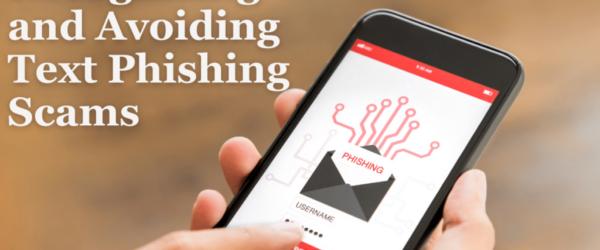 Hand holding smartphone with a phishing icon on it.