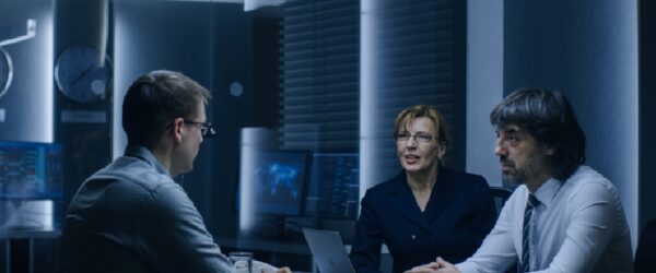 A team discussing Myrtle Beach IT solutions in a high-tech office at night.