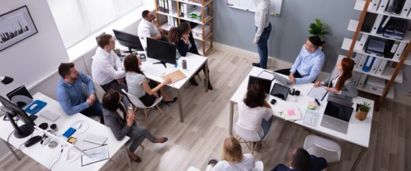 A Wilmington managed IT team in a meeting discussing strategy at their office.