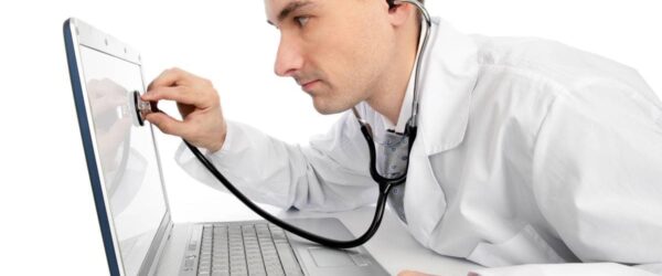 EOL, EOSL, and EOS – What’s the Difference A doctor examining a laptop, symbolizing Myrtle Beach managed IT services.