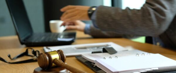 A Myrtle Beach law firm IT setup with laptop, gavel, and legal documents on desk.