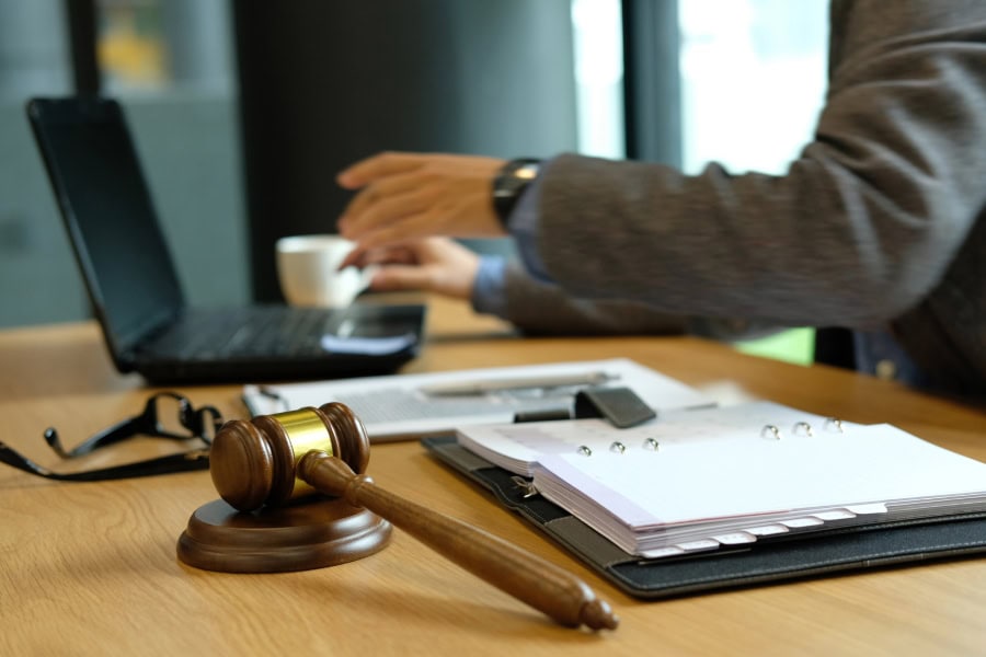 A Myrtle Beach law firm IT setup with laptop, gavel, and legal documents on desk.
