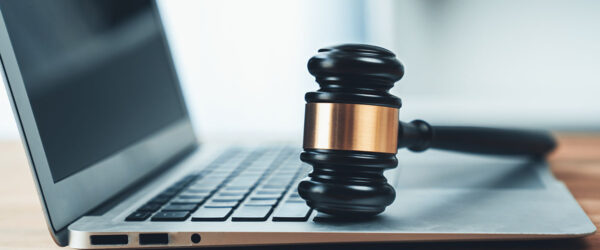 A gavel on a laptop, representing Wilmington managed services for law firms.