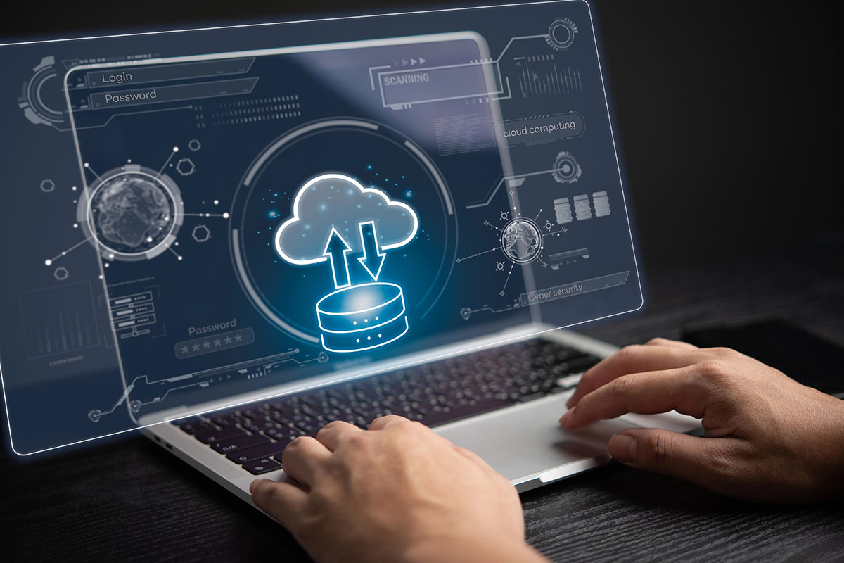 A person is typing on a keyboard showing a graphic of a server transferring data to a cloud.
