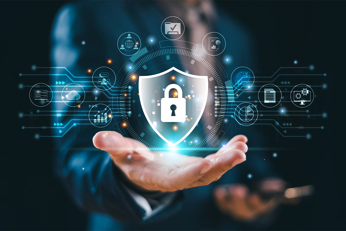 A businessman is holding out his hand to reveal a lock and shield icon with a circuit board pattern.