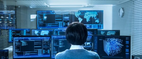 cybersecurity-threats-2026 A technician sitting in a remote support monitoring room.