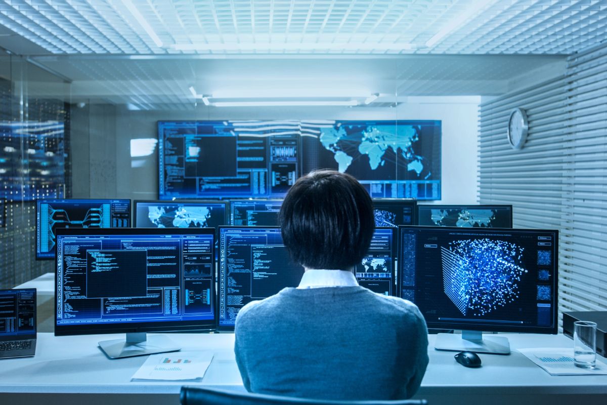 A technician sitting in a remote support monitoring room.