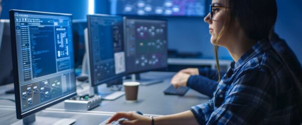 A woman using AI to improve cybersecurity on a client's network.