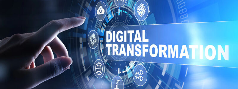 A hand reaching towards a digital interface displaying icons related to technology, with the words "DIGITAL TRANSFORMATION" prominently featured in the center.