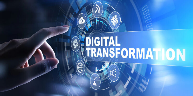 A hand reaching towards a digital interface displaying icons related to technology, with the words "DIGITAL TRANSFORMATION" prominently featured in the center.