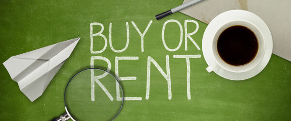 A green chalkboard with the words "BUY OR RENT" written in white chalk, accompanied by a paper airplane, a magnifying glass, a cup of coffee, a pen, and a piece of paper.