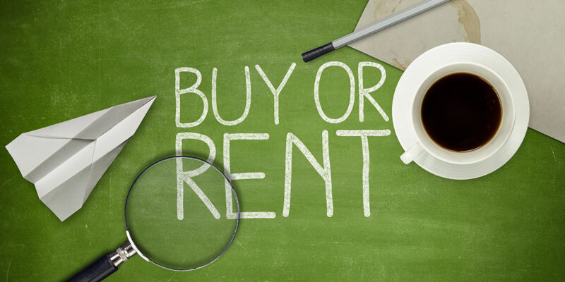 A green chalkboard with the words "BUY OR RENT" written in white chalk, accompanied by a paper airplane, a magnifying glass, a cup of coffee, a pen, and a piece of paper.