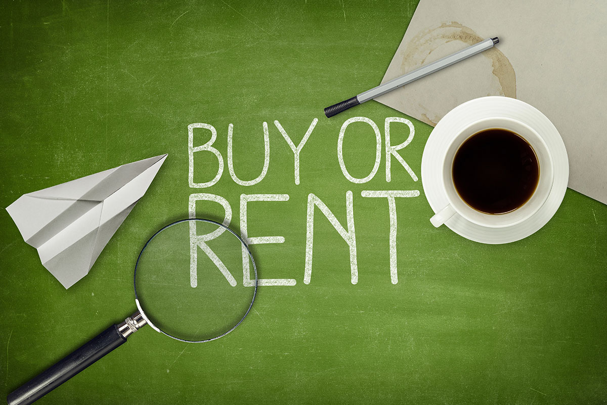 A green chalkboard with the words "BUY OR RENT" written in white chalk, accompanied by a paper airplane, a magnifying glass, a cup of coffee, a pen, and a piece of paper.