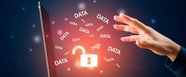A hand reaches toward a laptop displaying an open padlock and multiple instances of the word "DATA" floating around in a glowing, digital environment.