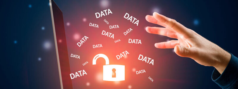 A hand reaches toward a laptop displaying an open padlock and multiple instances of the word "DATA" floating around in a glowing, digital environment.