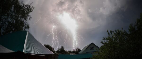 Lightning striking over a residential area.
