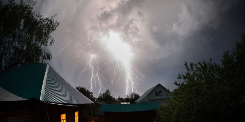 Lightning striking over a residential area.