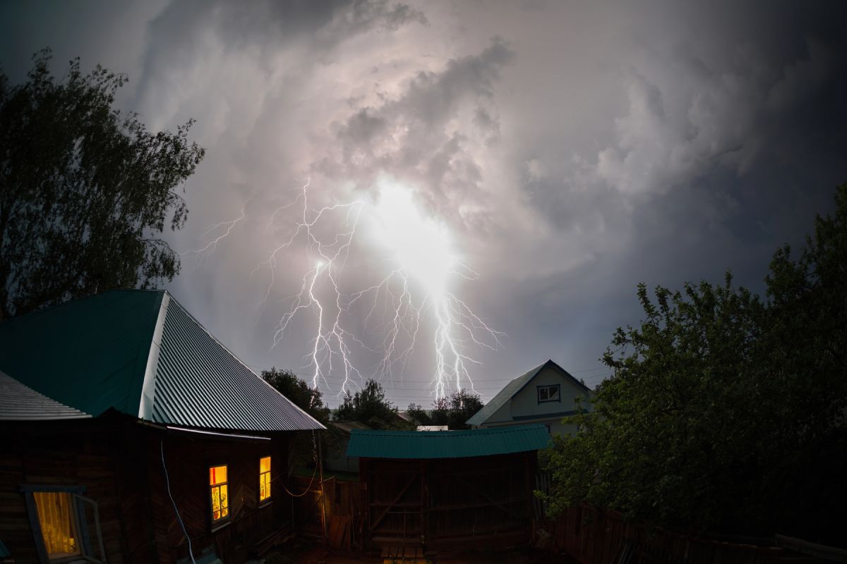 Lightning striking over a residential area.
