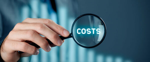 A person in a suit holds a magnifying glass over the word "COSTS," surrounded by a blurred background suggesting a business context.