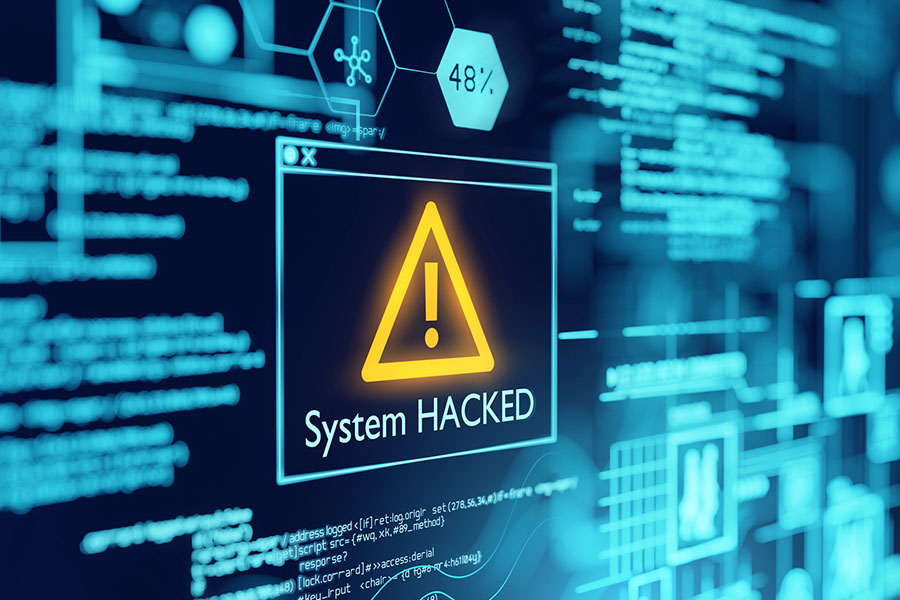 A digital display shows a warning message with an exclamation mark stating "System HACKED" against a backdrop of blue circuit-like graphics and lines of code.