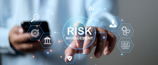 A person reaching out to tap a floating digital icon that reads "RISK MANAGEMENT" surrounded by business and technology symbols.